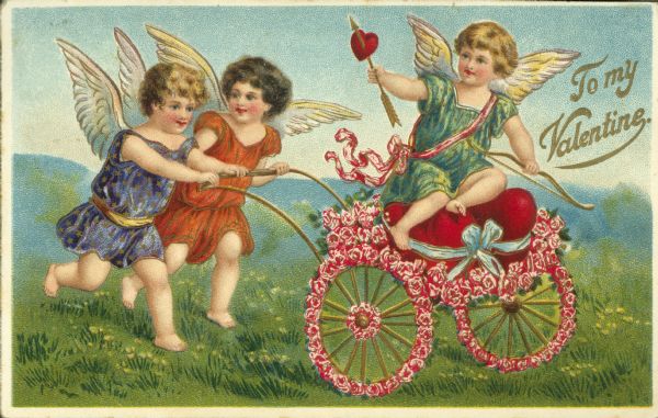 Valentine's Day postcard with Cupid holding a bow and arrow seated in a two wheeled cart made of flowers, two cherubs are pushing it. They are in a meadow with hills in the background. Text on the right reads "To My Valentine."