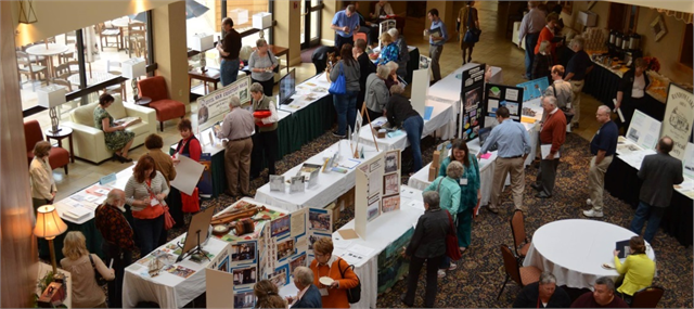 Conference attendees gathered around Town Square tables at a Local History-Historic Preservation Conference.