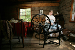 A woman spins some yarn.