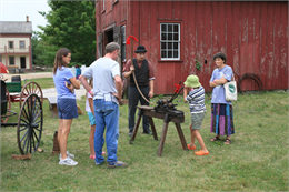 A steam tractor replaces horses on the farm.