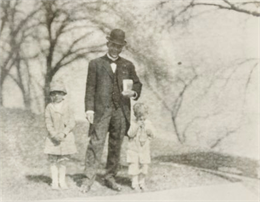 Snapshot of Booker T. Washington and two small children.