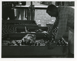 A volunteer grabs an ice-cold beer for a customer during a Road America race in 1960.
