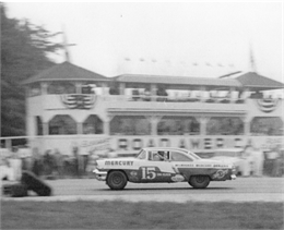 Tim Flock, racing past the Road America Pagoda, takes the checkered flag to win Sunday’s NASCAR Grand National race in his 1956 Mercury.