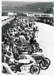 Bikes parked the in the pits prepare for the first motorcycle race at Road America, 1980