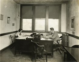 Martin P. Winther seated at desk.
