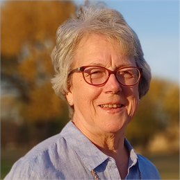 Author Mary Elise Antoine pictured wearing glasses and smiling.
