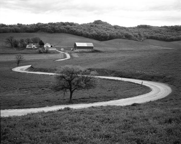 A winding road leading to a farm.