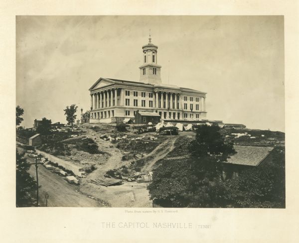 The Nashville, Tennessee capitol building is on a hill overlooking the city. Union soldiers have pitched tents on the grounds.