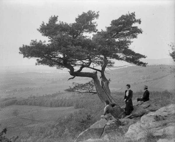 Two women and a man pose atop Gibraltar Rock in Richmond Memorial Park.