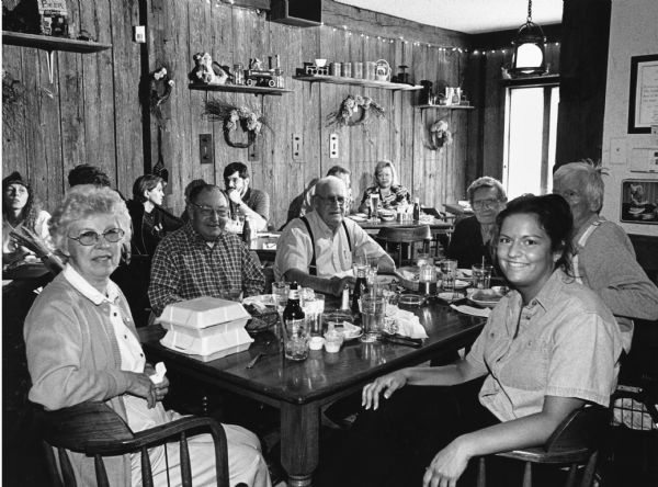 A table full of people pose for the camera in the Jail House Restaurant.