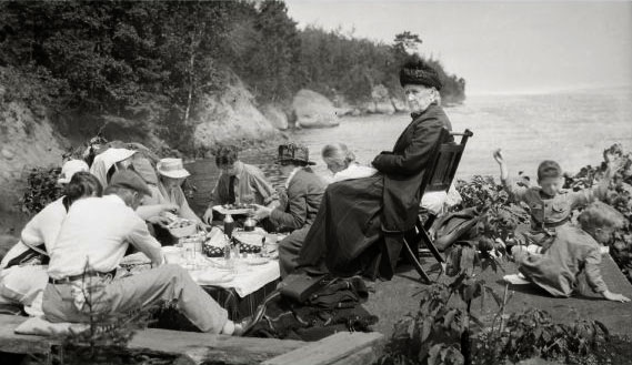 A family is having a picnic near the shore on Bass Island.