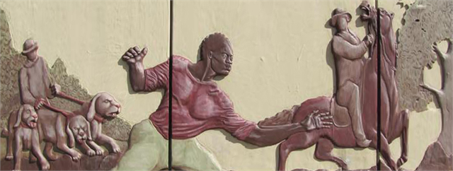 A mural depicting Joshua Glover escaping. He is running from dogs on his left, and appears to be going toward a man on a horse in the right side of the mural.