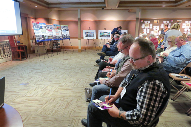 Attendees write down their favorite and most iconic Wisconsin memories, which were then placed onto "What Makes Wisconsin, Wisconsin?" theme boards along the wall.