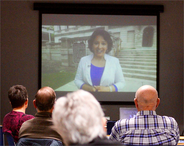 Guests in Manitowoc watch the Society's "What Makes Wisconsin, Wisconsin?" video featuring veteran Milwaukee television reporter Jessie Garcia. The video highlights the role of the Society and explains the new Wisconsin history museum project.