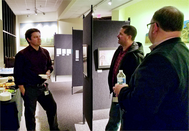 Christian Overland (right), the Ruth and Hartley Barker Director of the Wisconsin Historical Society, chats with guests at the "Share Your Voice" new state history museum listening session Feb. 12, 2019 at the Neville Public Museum in Green Bay.