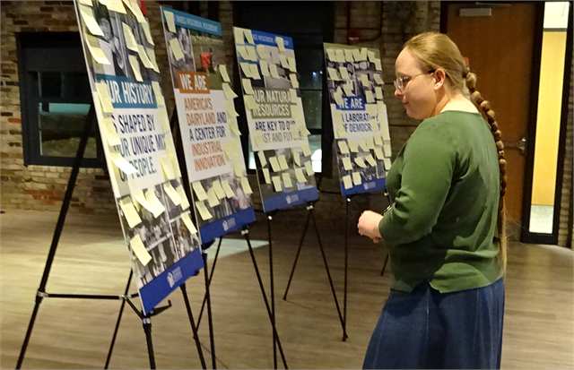 A guest looks over Post-It note suggestions that were posted on theme boards during the Wisconsin Historical Society's "Share Your Voice" new museum listening sessions Feb. 21, 2019 at the Goodman Community Center in Madison.