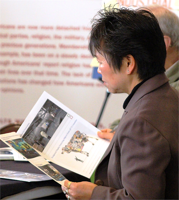 A woman examines new museum concept exhibit design renderings during the Wisconsin Historical Society's "Share Your Voice" listening session March 13, 2019 at The History Museum at the Castle in Appleton.