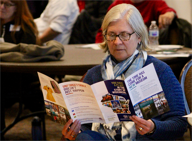 Cathi Wiebrecht-Searer, a Wisconsin Historical Foundation board member, looks over a pamphlet about the new Wisconsin history museum project prior to the "Share Your Voice" session April 10, 2019 in Madison.