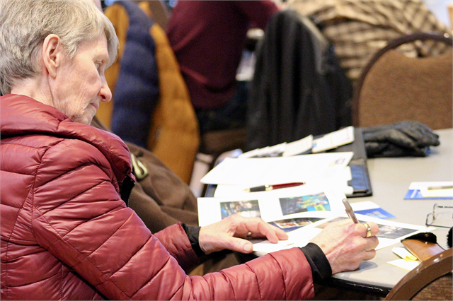 A woman writes down her thoughts about new museum concept exhibit renderings during the "Share Your Voice" session April 10, 2019 at Madison's Warner Park Community Recreation Center.