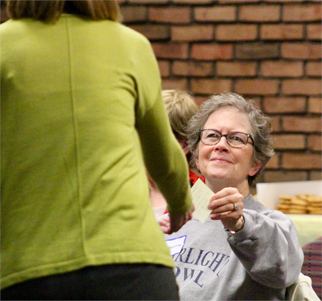 A woman hands her Post-It notes  to a Wisconsin Historical Society staff worker during the "Share Your Voice" new museum listening session April 17, 2019 in La Crosse. The notes were used to offer suggestions on what to include in a new museum.