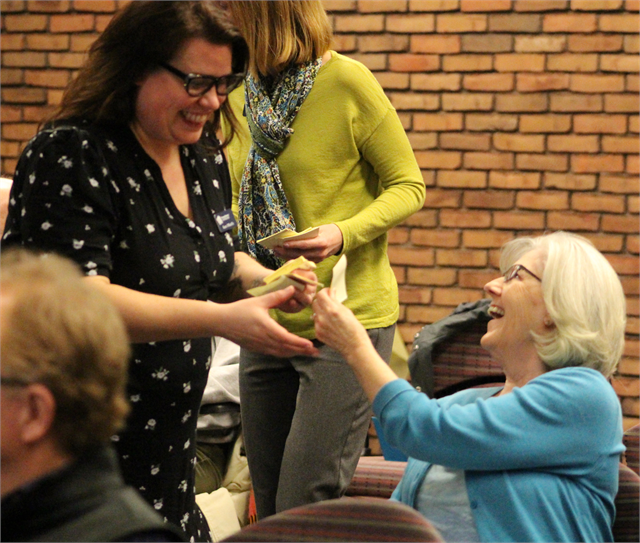 Jeannette Kaus enjoys a laugh as she hands her Post-It note to Kara O'Keeffe of the Society during the "Share Your Voice" new museum public listening session April 17, 2019 in La Crosse.