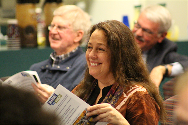 Local state Rep. Jill Billings (D-La Crosse) enjoys a laugh and looks over concept exhibit design renderings during the Wisconsin Historical Society's new museum public listening session April 17, 2019 at the La Crosse Public Library.