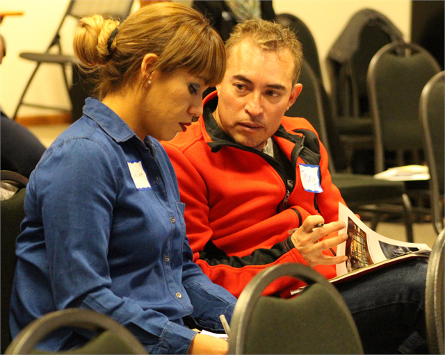 A couple discusses their comments as they review new museum materials during the Wisconsin Historical Society's "Share Your Voice" multicultural listening session for the area Latinx community May 8, 2019 in Fitchburg.