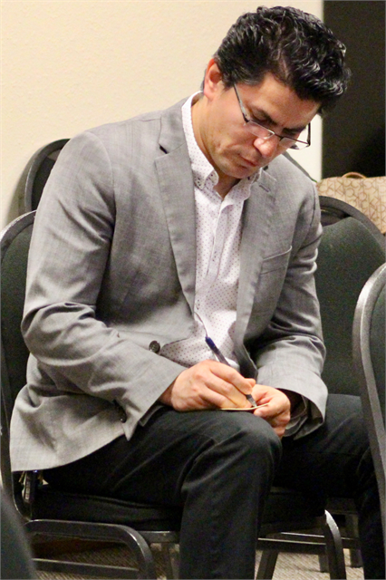 A guest writes his comments about new museum concept exhibit design renderings during the Wisconsin Historical Society's "Share Your Voice" multicultural listening session for the Latinx community May 8, 2019 in Fitchburg.