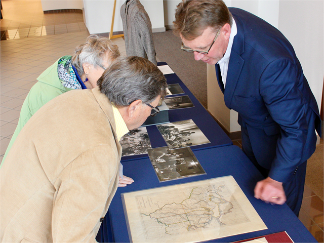 Matt Blessing, State Archivist and Director of Library, Archives and Museum Collections for the Wisconsin Historical Society, shows John Thomas and JoAnn Schwenk Carlson a map from 1814 of the U.S. Territory that became Wisconsin and Minnesota.