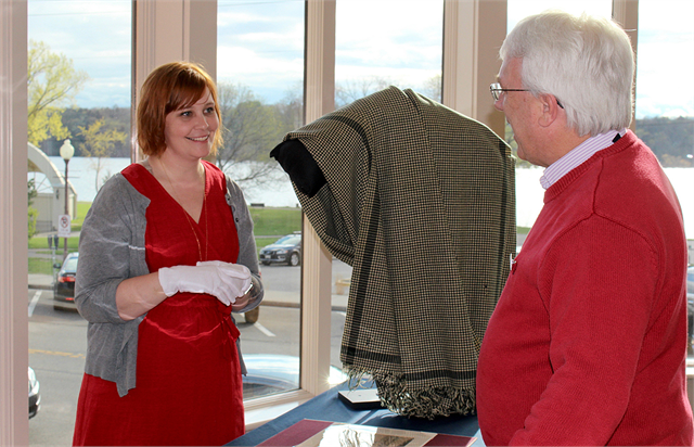 Simone Munson, Collections Director of the Wisconsin Historical Society, chats with Brent Peterson, director of Minnesota's Washington County Historical Society, as he examines a shawl worn by Abraham Lincoln.