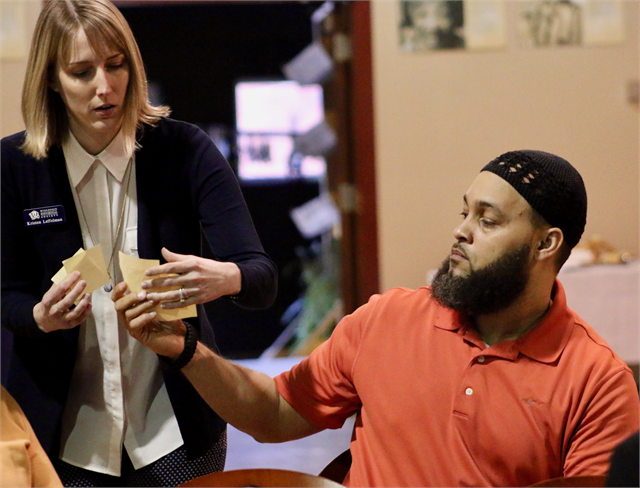 A guest gives his Post-It notes with new museum idea suggestions to Kristen Leffelman of the Wisconsin Historical Society staff during the "Share Your Voice" listening session May 14, 2019 at the Wisconsin Black Historical Society and Museum.