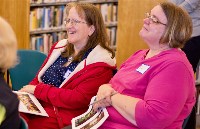 Women laugh as another guest shares a story during the Wisconsin Historical Society's "Share Your Voice" new museum listening session May 23, 2019 at the Racine Public Library.