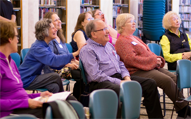 Holli Rosenberg pats another guest on the shoulder during a discussion at the Wisconsin Historical Society's "Share Your Voice" new museum listening session May 23, 2019 at the Racine Public Library.