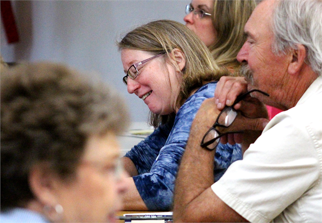 Tammy Schutz, Director of the Barron County Historical Society, smiles as she writes comments during the Wisconsin Historical Society's "Share Your Voice" new museum listening session for Barron County residents at the Cameron Senior Center.