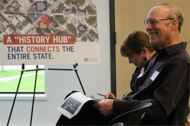 James Hardy of Rhinelander laughs at a comment while his wife, Diane Dei Rossi, writes comments on a packet of exhibit design renderings during the Wisconsin Historical Society's "Share Your Voice" new museum session May 30, 2019 in Eagle River.