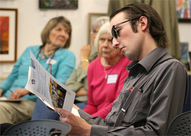 A young man at a listening session in Eagle River reviews concept exhibit design renderings for a new state history museum the Wisconsin Historical Society is planning to build in Madison.