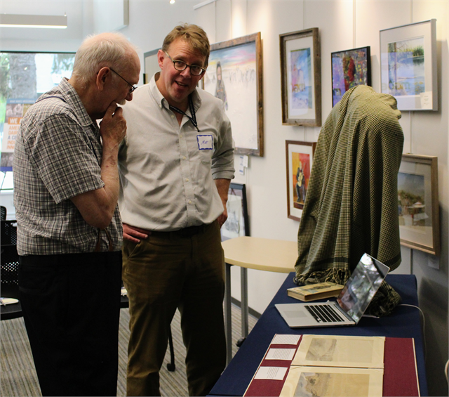 Craig Moore, left, and Matt Blessing, the Director of the Wisconsin Historical Society's Library, Archives and Museum Collections, discuss rare artifacts from the Society's collections on display at the new museum listening session in Eagle River.