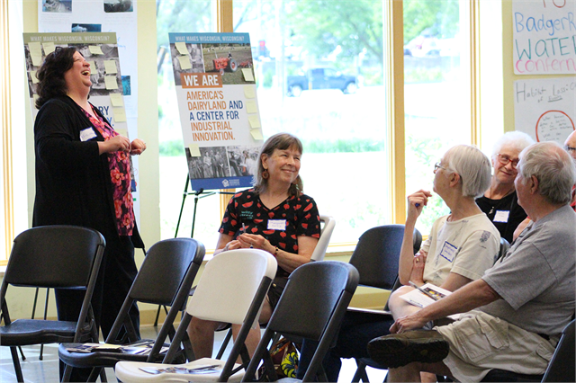 Alicia Goehring of the Wisconsin Historical Society enjoys a laugh with guests June 8, 2019 at the "Share Your Voice" new museum listening session at the Badger Rock Neighborhood Center in Madison.