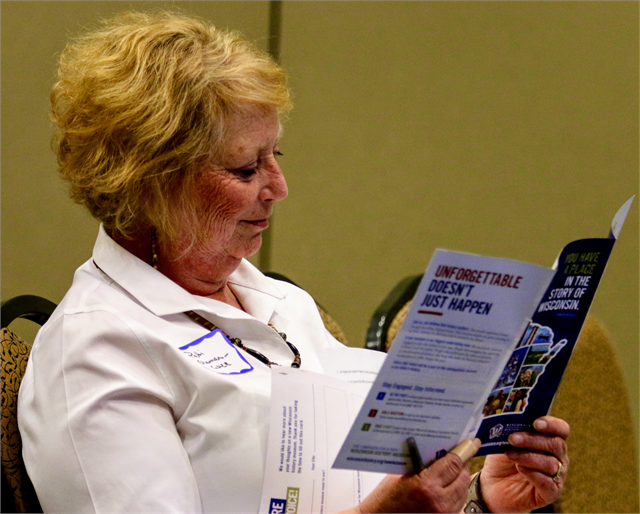 Patti Sherman-Cisler, Executive Director of Jewish Museum Milwaukee, looks over a brochure of information about the new Wisconsin state history museum project during the Wisconsin Historical Society's listening session in Whitefish Bay.