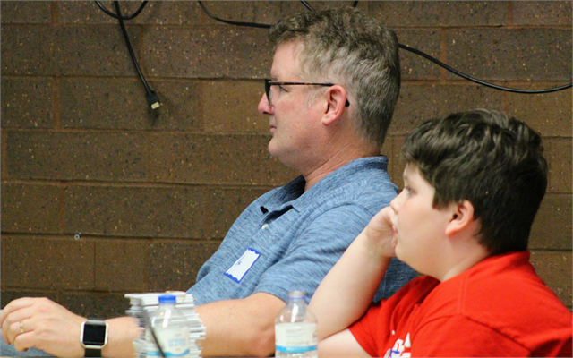 Paul Seymour and his son, Thomas, watch a Wisconsin Historical Society film describing the main storytelling theme for a new state history museum, "What Makes Wisconsin, Wisconsin?" during the Society's listening session June 5, 2019 in Eau Claire.