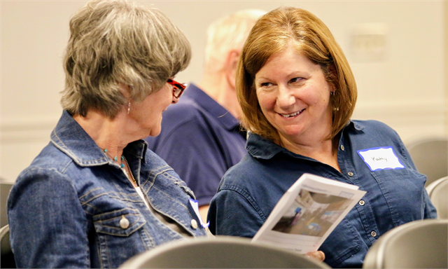 Gloria Maki, left, and Kathy Behlke joke with each other as they review concept exhibit design renderings during the Wisconsin Historical Society's "Share Your Voice" new museum listening session June 25 at the Fond du Lac Public Library.