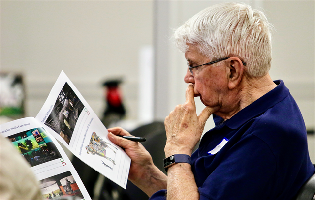 Dr. Fred Born examines new museum concept exhibit design renderings during the listening session in Fond du Lac. He said he "liked the idea" of an art installation like the cow, but "I would rather had the [shape of] the state of Wisconsin," he said.