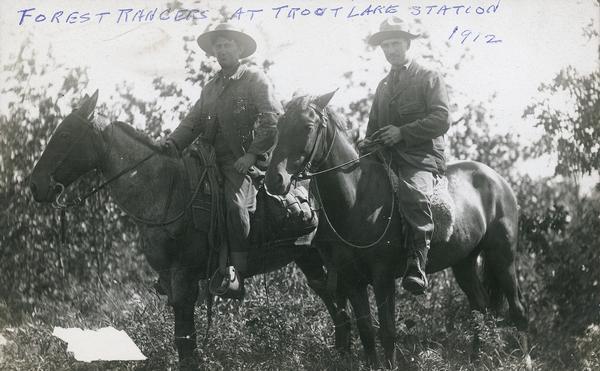 Two forest rangers on horseback at Trout Lake Station.