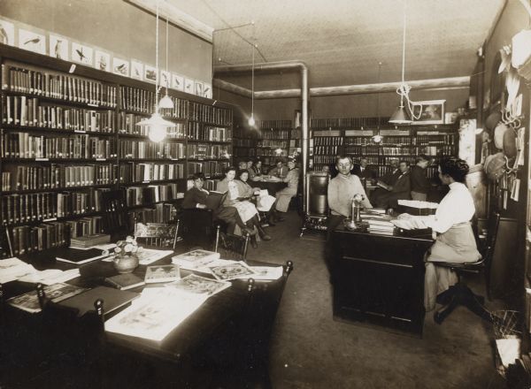 Interior view of the Brodhead Public Library, occupied by several people.