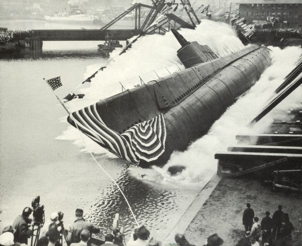 A submarine lying on its side in the lake after being launched.