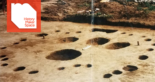 Holes dug in a circle on the ground with four larger holes in the middle