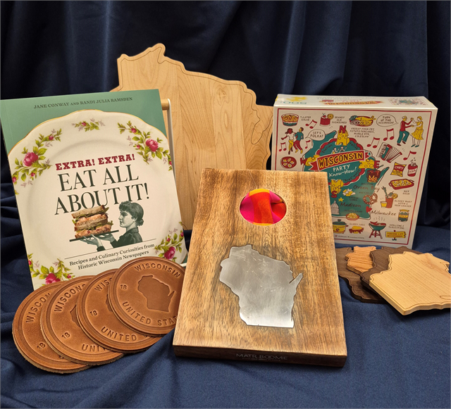 Wisconsin-themed cookbook, coasters, Wisconsin shaped cutting boards, a state puzzle, and a tabletop cornhole game