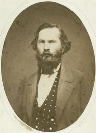 Studio portrait of Byron Paine in suit.