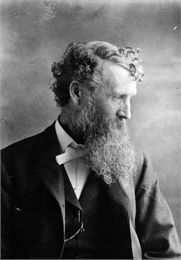 Black and white waist-up studio portrait of naturalist, conservationist and writer John Muir.