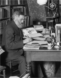 Rasmus Anderson seated in his study and taking notes from a book.